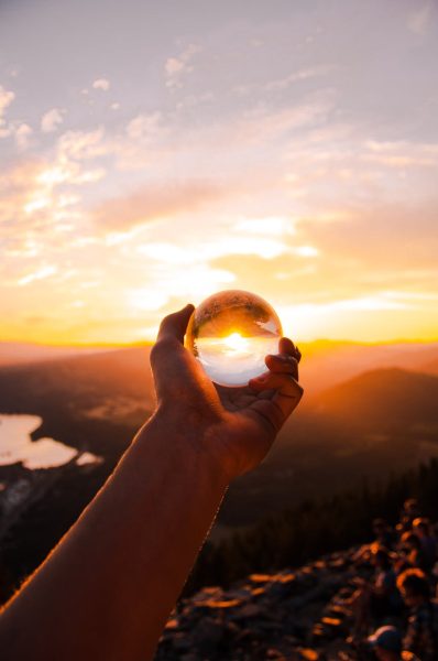 person holding a glass ball